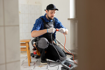 Sticker - Connecting cables with a plug, extension cord plugging in construction equipment, breakdown, short circuit in house during renovation experienced man in field of electricity repairs electrical.