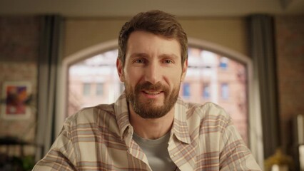 Wall Mural - Handsome Caucasian Man Making a Video Call from Home Living Room with Big Window. Happy Project Manager Working Remotely, Talking to Colleague Online Over a Live Conference Software. POV Footage.