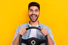 Photo Of Overjoyed Carefree Crazy Person Guy Tests New Road Hold Wheel Isolated On Yellow Color Background