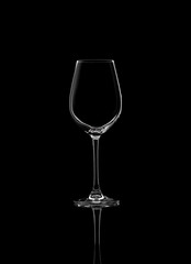 Wall Mural - Empty glass for white wine isolated on black background