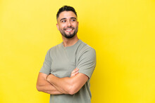 Young Arab Handsome Man Isolated On Yellow Background With Arms Crossed And Happy