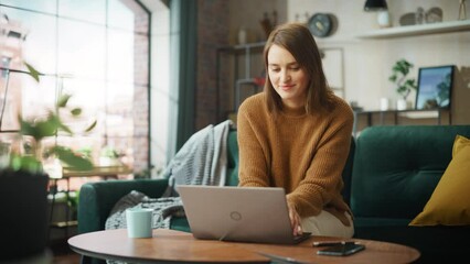 Poster - Portrait of Smiling Young Woman Working from Home on Laptop Computer in Sunny Cozy Apartment. Successful Creative Girl Entrepreneur Does Remote for e-Business Project, Online Shopping