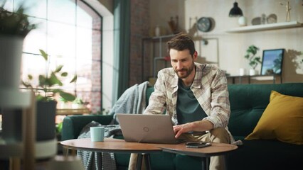 Aufkleber - Portrait of Smiling Middle Aged Man Working from Home on a Laptop Computer in Sunny Cozy Apartment. Successful Male Entrepreneur Does Remote for e-Business Project, Online Shopping. Zoom Out