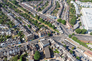 aerial view of the area of highams park including the railway line and level crossing