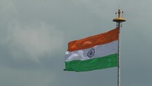 Indian Tricolor National Flag Also Called As Hindustan Bharat Ka Lehrata Tiranga Jhanda Or Rashtriya Dhwaj Hoisted Waving In Air Against Moving Cloud On Blue Sky On Independence Day