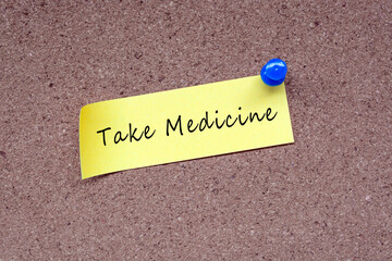 Wall Mural - Take medicine words on stick note and pinned to a cork notice board.