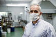 Italian European worker working in food factory portrait waring face mask for hygiene