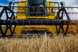 © ADDICTIVE STOCK - Combine harvester in agricultural field