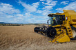 © ADDICTIVE STOCK - Combine harvester in agricultural field