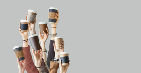 Many different arms raised up holding coffee cup