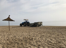 Tractor Cleaning The Sand In The Beach