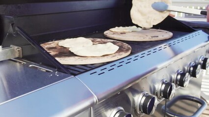 Wall Mural - Cooking flatbread on outdoor gas grill.