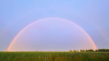 Full Rainbow In The Field By The Road. Double Rainbow