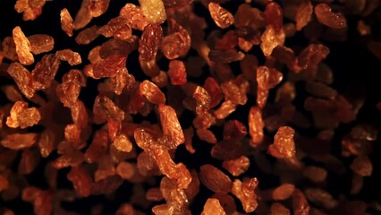 Sticker - Raisins go up and fall down. On a black background. Top view. Filmed on a high-speed camera at 1000 fps.