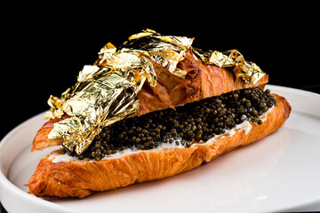 Poster - golden croissant with caviar, croissant for breakfast. Luxury breakfast.