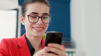Poster - office worker browsing internet on smartphone at desk, texting messages on break after working with 