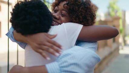 Wall Mural - African american women mother and daughter hugging each other at street