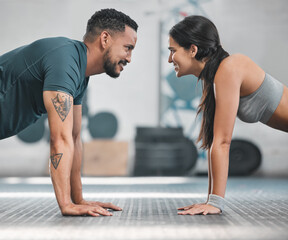 Wall Mural - Fitness, health and active couple training together in a gym doing exercise workout for healthy lifestyle. Young and focused athletic friends doing pushups indoor. Good teamwork for wellness goals