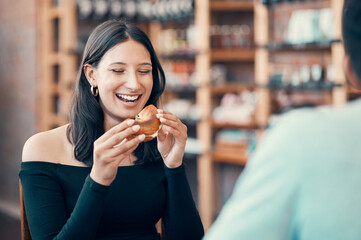 Poster - Happy, beautiful and relaxed woman eating on a date at a restaurant with her partner on the weekend. Young and attractive female enjoying a meal or breakfast burger at a cafe with her boyfriend