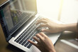 © CA[P]IXEL - Cropped image of a woman working on  laptop