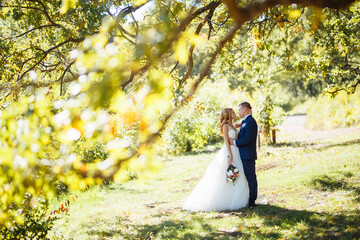 Happy wedding couple enjoy each other in the park. Wedding day. Marriage. The concept of youth, love, fashion and lifestyle.