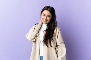 Wall Mural - young caucasian woman isolated on purple background laughing