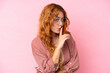 © luismolinero - Young caucasian woman isolated on pink background With glasses and doing silence gesture