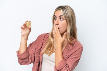 Wall Mural - Young caucasian woman holding a Bitcoin isolated on white background with surprise and shocked facial expression