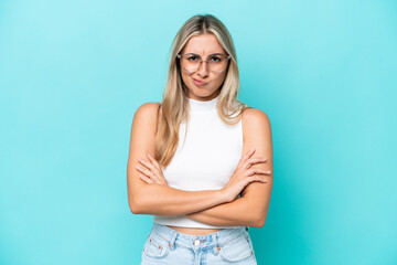 Wall Mural - Young caucasian woman isolated on blue background with unhappy expression