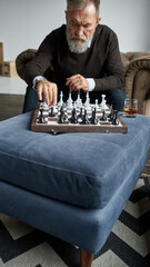 Wall Mural - Elderly man playing chess with himself at home