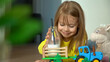 © Belkina Margarita - Close up of happy little girl lies on floor, smiles and drinks milk from bottle with straw