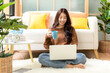 © freebird7977 - Happy young woman working and meeting online at home.  Lifestyle freelance relax and chill drinking coffee in living room, Nature garden background.  Lifestyle Concept