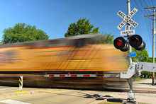 Freight Train In Motion Speeding At Crossing Gate