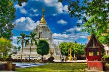 The Chedi Of The Wat Chang Kam Phra (also Called  Wat Kan Thom Or Kanthom), Nong Phueng, Saraphi District, Chiang Mai, Thailand, With Several Statues And A White Tree Support
