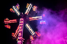 Fun Fair Rides At Night With Colorful Lights