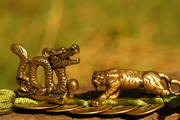 Wall Mural - Tiger and dragon figurine with Chinese coins. A religious symbol. Feng shui figurines.