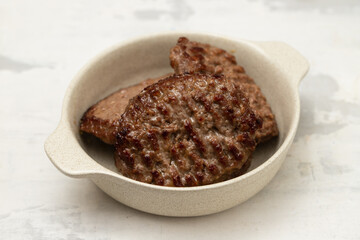 Sticker - fresh grilled hamburgers in small bowl on ceramic