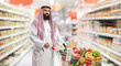 © Ljupco Smokovski - Saudi arab man with a shopping cart full of food products in a supermarket