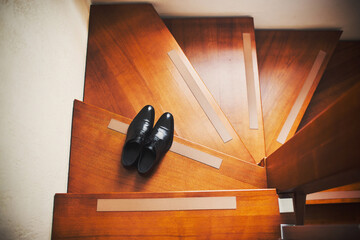 Wall Mural - Black wedding shoes stand on wooden steps