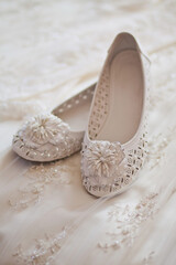 Sticker - White shoes lie on a wedding dress