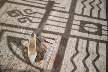 Wall Mural - Beige lace wedding shoes on stone floor