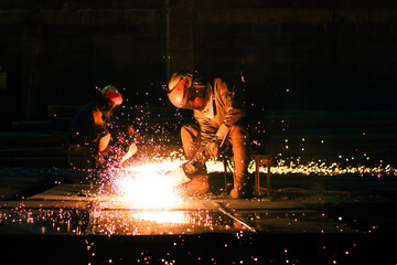 Wall Mural - Worker welding steel at industrial workplace