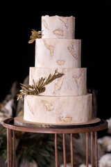 Wall Mural - Multilevel wedding cake decorated with gold flowers
