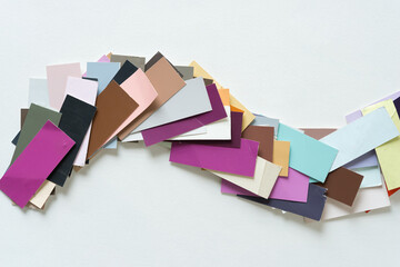 Wall Mural - heap of layered paint sample pieces on blank paper (violet and brown)