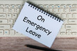 © JeromeMaurice - On emergency leave text on white notepad with pen and keyboard background.