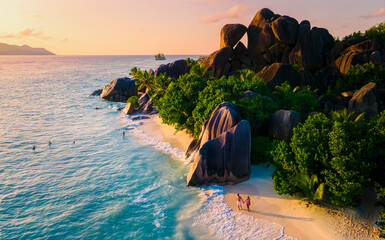 Anse Source d'Argent, La Digue Seychelles, a young couple of men and women on a tropical beach during a luxury vacation in Seychelles. Tropical beach Anse Source d'Argent, La Digue Seychelles