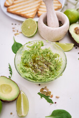 Wall Mural - Toasts preparation - Mashed avocados in a glass bowl