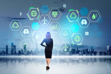 Wall Mural - Businesswoman and New York cityscape, green energy digital hud icons