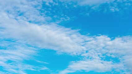 the formation of storm clouds before rain. a sunny summer sky changing from blue and cloudless to br