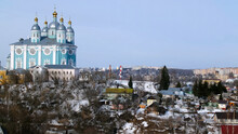 Beautiful Blue Temple On Background Of City In Winter. Stock Footage. Assumption Cathedral In Smolensk Rises Above City On Background Sky